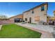 Backyard showcasing artificial turf, brick trim, a concrete patio, block wall, grill, and furniture at 5736 Clear Haven Ln, North Las Vegas, NV 89081