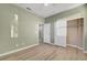 This bedroom features light green walls, wood flooring, and a closet with white doors at 5736 Clear Haven Ln, North Las Vegas, NV 89081