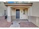 Inviting front porch features a brick pathway leading to the arched entryway and a solid front door at 5736 Clear Haven Ln, North Las Vegas, NV 89081