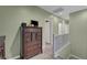 Upstairs hallway with green walls, hardwood floors, and a dark wood dresser at 5736 Clear Haven Ln, North Las Vegas, NV 89081