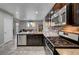 Spacious kitchen featuring stainless steel appliances, granite countertops, and dark wood cabinetry at 5736 Clear Haven Ln, North Las Vegas, NV 89081