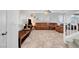 Spacious living room with tile flooring, a ceiling fan, and comfortable brown leather furniture at 5736 Clear Haven Ln, North Las Vegas, NV 89081