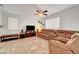 Inviting living room featuring comfortable sofas, a ceiling fan, and natural light at 5736 Clear Haven Ln, North Las Vegas, NV 89081