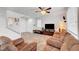 Bright living room with neutral walls, comfortable seating, and tile floors at 5736 Clear Haven Ln, North Las Vegas, NV 89081