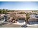 Lovely aerial view of homes with desert landscaping, tile roofs and multi-car garages, showing community layout at 5891 Alfano Ave, Pahrump, NV 89061