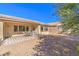 Relaxing backyard with a tiled patio, desert landscaping, and a covered seating area, perfect for outdoor enjoyment at 5891 Alfano Ave, Pahrump, NV 89061