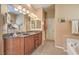 Spacious bathroom featuring a double vanity with granite countertops and ample cabinet space at 5891 Alfano Ave, Pahrump, NV 89061