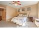 Cozy main bedroom featuring carpet, ceiling fan, and neutral wall tones at 5891 Alfano Ave, Pahrump, NV 89061