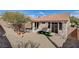 Low-maintenance backyard with gravel, a covered patio, and mature landscaping at 5965 Poplar Tree St, Las Vegas, NV 89148