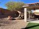 Desert landscaped backyard featuring a covered patio, gravel, rocks and rock landscaping at 5965 Poplar Tree St, Las Vegas, NV 89148