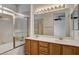 Bathroom featuring a double sink vanity, shower, and a large mirror at 5965 Poplar Tree St, Las Vegas, NV 89148