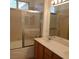 Bathroom with a shower-tub, vanity, and a large mirror with vanity lights at 5965 Poplar Tree St, Las Vegas, NV 89148