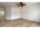 Spacious bedroom featuring wood-look floors and a unique leaf-style ceiling fan at 5965 Poplar Tree St, Las Vegas, NV 89148