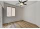 Bedroom featuring ceiling fan, wood-look floors, window with blinds, and neutral colors at 5965 Poplar Tree St, Las Vegas, NV 89148