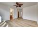 Bright bedroom with wood-look floors, white walls, and a leaf-style ceiling fan at 5965 Poplar Tree St, Las Vegas, NV 89148