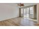 Sun-drenched bedroom featuring wood-look flooring, and sliding glass doors to the backyard at 5965 Poplar Tree St, Las Vegas, NV 89148