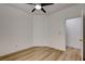 Light and airy bedroom boasts a modern ceiling fan, light-colored floors, and white walls at 5965 Poplar Tree St, Las Vegas, NV 89148