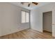 Light and bright bedroom featuring wood-look floors, ceiling fan, closet, and window at 5965 Poplar Tree St, Las Vegas, NV 89148