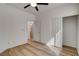 A simple bedroom featuring wood-look floors, ceiling fan, closet, and ensuite access at 5965 Poplar Tree St, Las Vegas, NV 89148