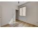 A sunlit bedroom with wood-look floors, closet, and window with vertical blinds at 5965 Poplar Tree St, Las Vegas, NV 89148