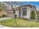 Low angle view of a single-story home showcasing the well-kept lawn and traditional architecture under a sunny, blue sky at 5965 Poplar Tree St, Las Vegas, NV 89148