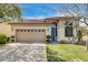 Charming single-story home featuring a well-manicured lawn and a classic two-car garage with traditional design elements at 5965 Poplar Tree St, Las Vegas, NV 89148