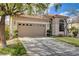 Beautiful single-story house with a tile roof, inviting front lawn, and a spacious two-car garage offering curb appeal at 5965 Poplar Tree St, Las Vegas, NV 89148