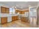 Charming kitchen featuring wood cabinetry, white appliances, tile countertops, and wood flooring at 5965 Poplar Tree St, Las Vegas, NV 89148