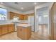 Bright kitchen featuring a central island, white appliances, and wood cabinets at 5965 Poplar Tree St, Las Vegas, NV 89148