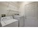 This practical laundry room includes shelving and a white door at 5965 Poplar Tree St, Las Vegas, NV 89148