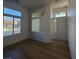 Bright living room with tile entryway, laminate flooring, and a pass-through window at 5965 Poplar Tree St, Las Vegas, NV 89148