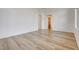 Bright living room featuring wood-look flooring and an open floorplan at 5965 Poplar Tree St, Las Vegas, NV 89148