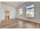 Bright living room featuring wood-look flooring and multiple windows for natural light at 5965 Poplar Tree St, Las Vegas, NV 89148