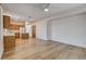 Open living space featuring wood floors and a view of the kitchen with wood cabinets at 5965 Poplar Tree St, Las Vegas, NV 89148