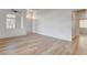 Bright living room featuring wood-look flooring and a view of the front entry at 5965 Poplar Tree St, Las Vegas, NV 89148