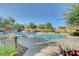 Inviting community pool area with ample lounge chairs and clear blue water surrounded by lush landscaping at 5965 Poplar Tree St, Las Vegas, NV 89148