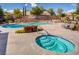 Inviting community pool and spa area, surrounded by lush landscaping and lounge chairs at 5965 Poplar Tree St, Las Vegas, NV 89148