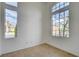 Small, bright room featuring tile flooring, two big picture windows, and light walls creating a pleasant, adaptable space at 5965 Poplar Tree St, Las Vegas, NV 89148