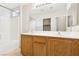 Bathroom with a double sink vanity, large mirror, and shower-tub combination at 6116 Casa Antiqua St, North Las Vegas, NV 89081