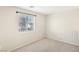 Bright bedroom featuring neutral carpeting and a window with modern blinds at 6116 Casa Antiqua St, North Las Vegas, NV 89081