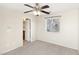 A standard-sized bedroom, with a window, ceiling fan, and sliding door leading to an exterior balcony at 6116 Casa Antiqua St, North Las Vegas, NV 89081