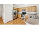 Kitchen featuring stainless steel appliances, ample cabinet space, and hardwood floors at 6116 Casa Antiqua St, North Las Vegas, NV 89081