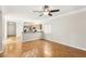 Bright living room with hardwood floors open to the kitchen with a breakfast bar at 6116 Casa Antiqua St, North Las Vegas, NV 89081