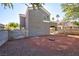 View of backyard and home exterior with desert landscaping and block wall at 6628 Silver Penny Ave, Las Vegas, NV 89108