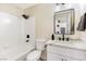 Bathroom featuring a shower-tub combo, modern vanity, and a sleek, black framed mirror at 6628 Silver Penny Ave, Las Vegas, NV 89108