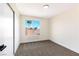 Bedroom featuring a closet, neutral carpeting, and a large window offering natural light and neighborhood views at 6628 Silver Penny Ave, Las Vegas, NV 89108