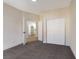 Carpeted bedroom features neutral paint, closet and access to nearby kitchen at 6628 Silver Penny Ave, Las Vegas, NV 89108