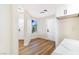 Inviting entryway featuring wood floors, a white door, and a view to the outside at 6628 Silver Penny Ave, Las Vegas, NV 89108