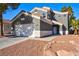 Exterior elevation featuring desert landscaping, two-car garage and a tile roof at 6628 Silver Penny Ave, Las Vegas, NV 89108