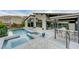 Expansive backyard with a pool, spa, fire pit, and outdoor kitchen, perfect for entertaining at 6832 Apogee Ridge Ct, Las Vegas, NV 89135